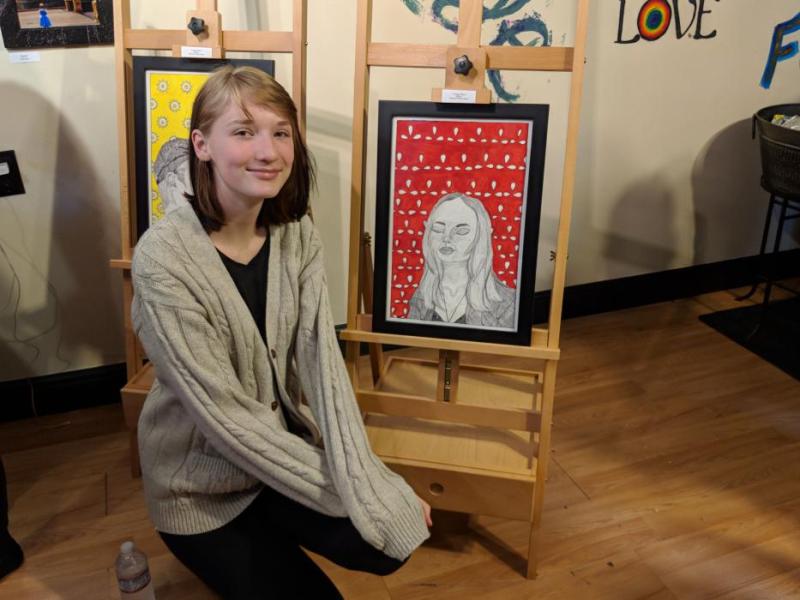 Shannon Rose next to her piece, "A Happy Place"