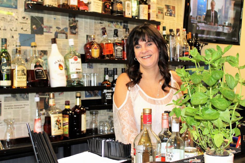 Bella Vita Bistro owner Lori Baxter uses grown basil to provide flavor to her freshly prepared dishes. Photo by Ronni Hannaman