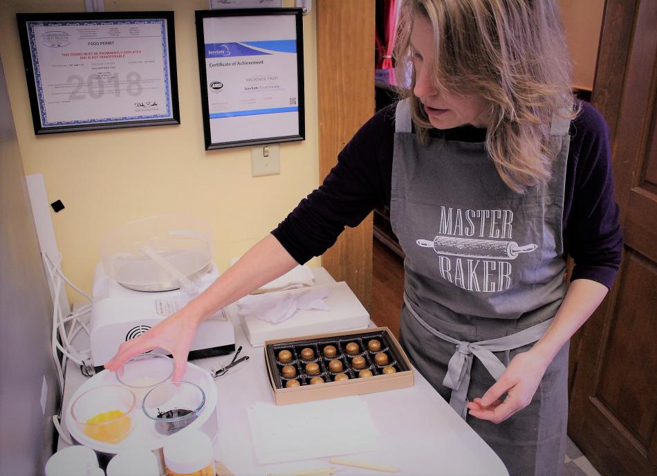 Laura Fink prepares to put the finishing artwork on a batch of Lavender Honey chocolates.