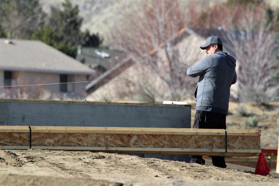 Photos by Brett Fisher. A concrete foundation is measured in the Silver Oak Development.