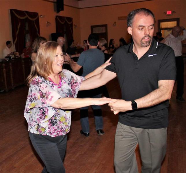 Photos by Brett Fisher. A couple dances inside the upstairs ballroom at the Brewery Arts Center.