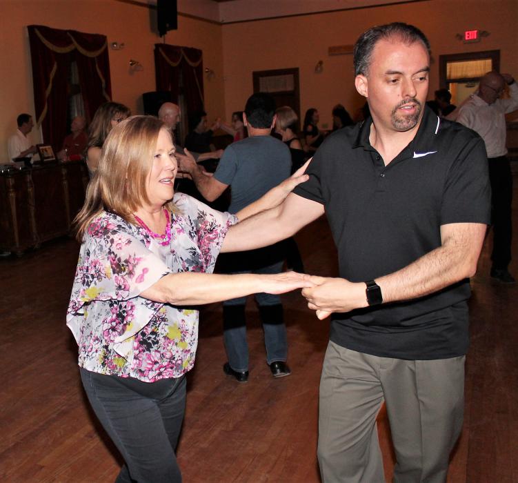 Photos by Brett Fisher. A couple dances inside the upstairs ballroom at the Brewery Arts Center.