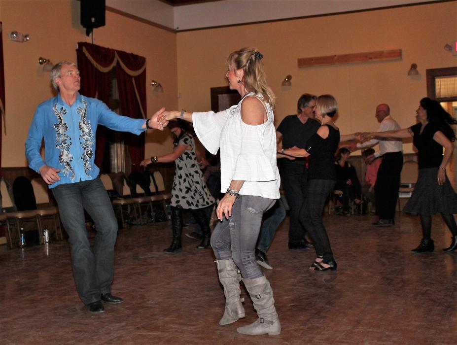 Dancers on the floor of the upstairs ballroom at the Brewery Arts Center.
