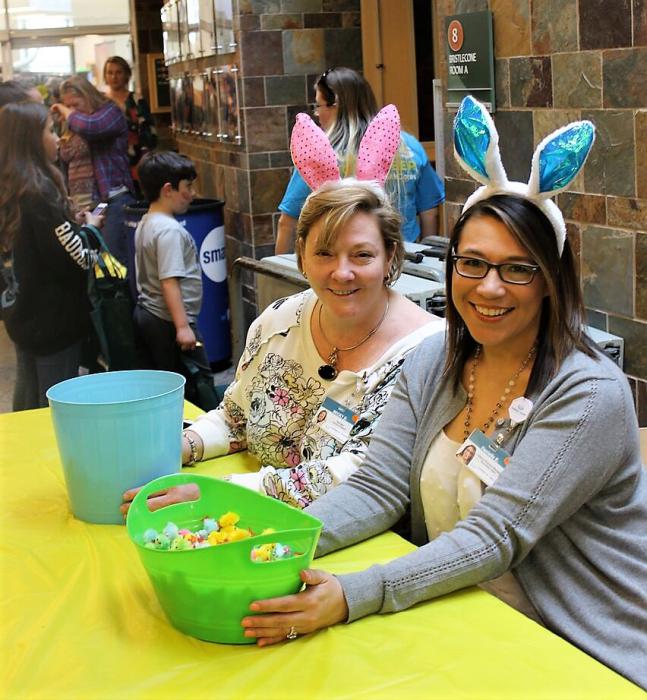 Carson Tahoe employees staff a table with candy.