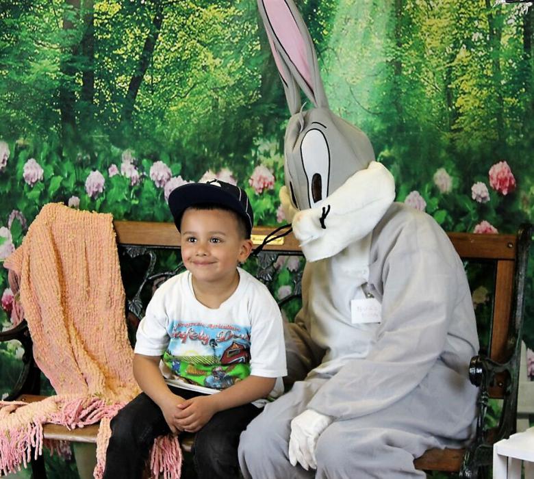 The Easter Bunny poses for a photo with a child Thursday at Carson Tahoe Hospital.