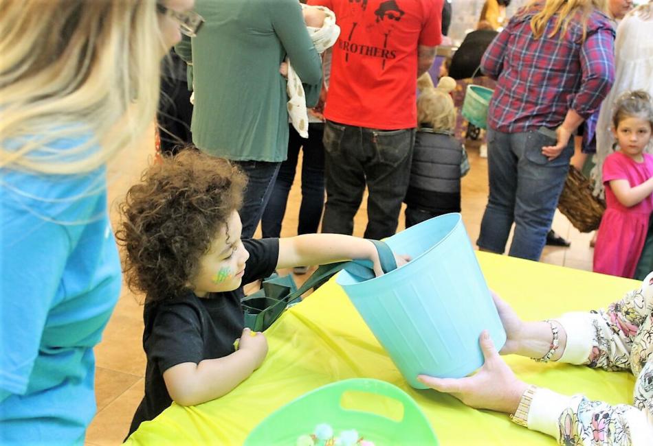 A child reaches in a bucket for goodies during Carson Tahoe's Eggstravaganza.