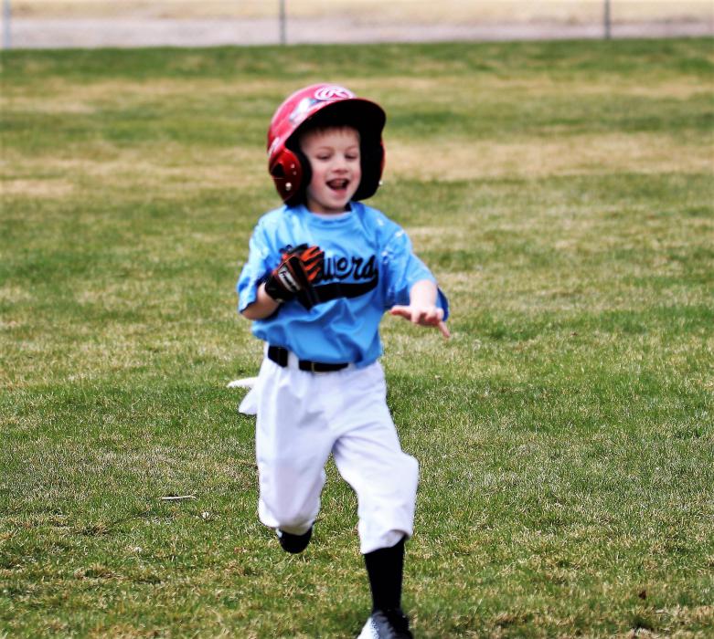 Photos by Brett Fisher. A t-ball player runs to second base during a game Saturday at Governor's Field.