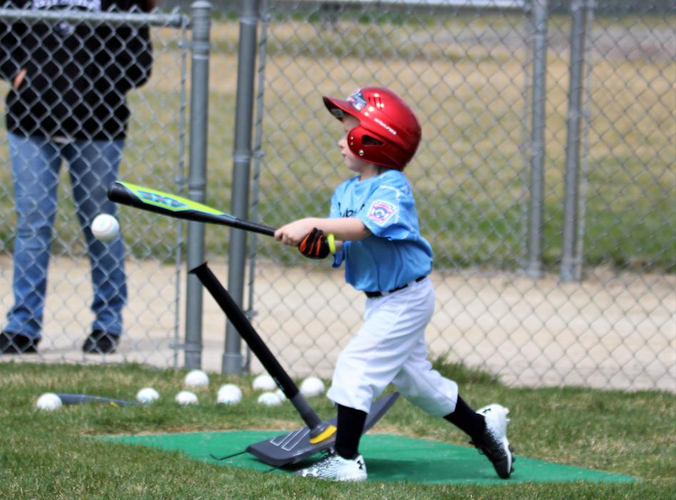 A t-ball player connects on a hit into the infield Saturday at Governor's Field.