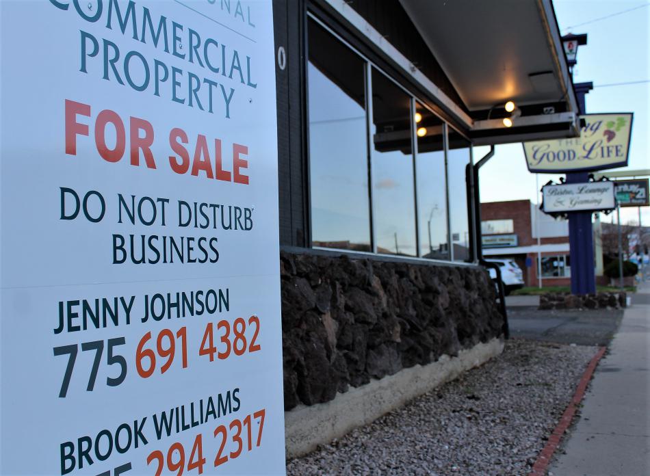 The for sale sign out in front of the building at 1480 North Carson Street.
