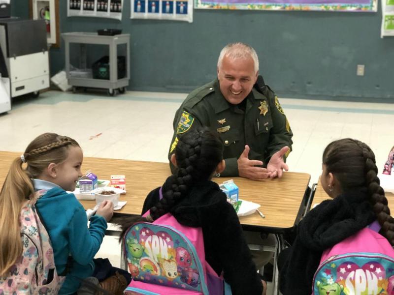 Patrol Sgt. Jim Primka with the Carson City Sheriff's Office visits with 1st graders.