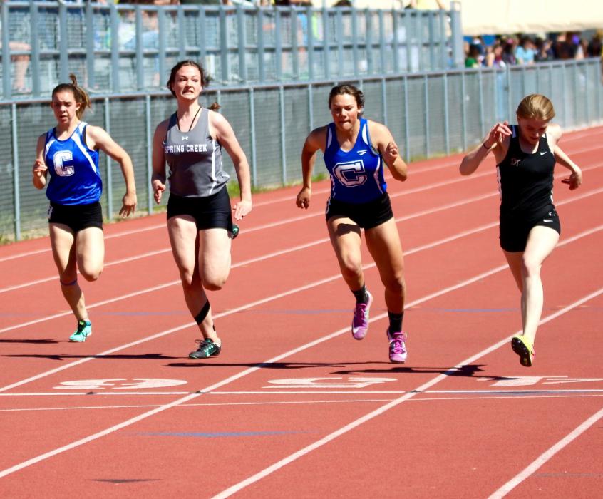 CHS 100 meter dash sprinters lean toward the finish line.