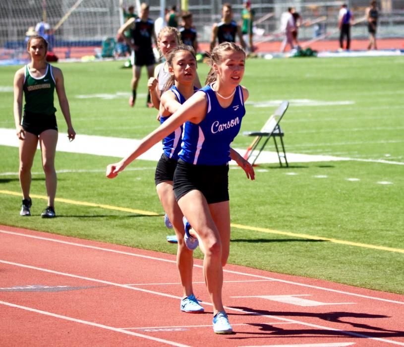 CHS relay sprinters make the baton exchange.