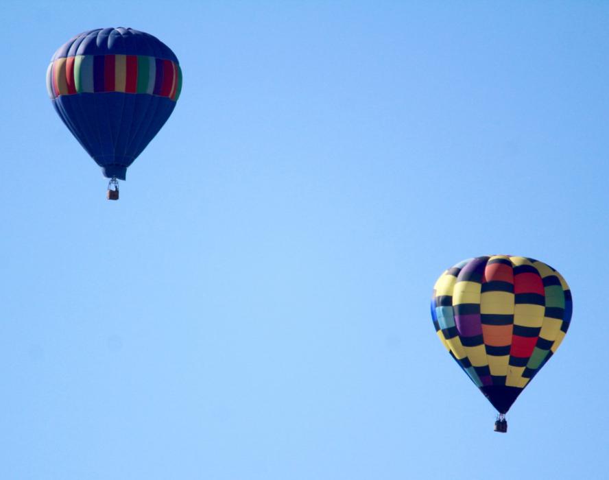 Two of three hot air balloons float above South Carson City Sunday morning.