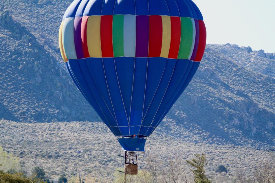 A hot air balloon gains lift to avoid touch down in a Southeast Carson City neighborhood Sunday morning.