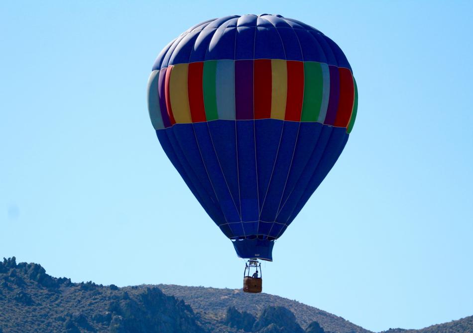 A hot air balloon gains lift over Prison Hill Sunday morning.