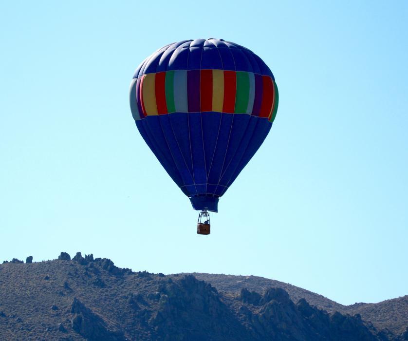 A hot air balloon gains lift over Prison Hill Sunday morning.