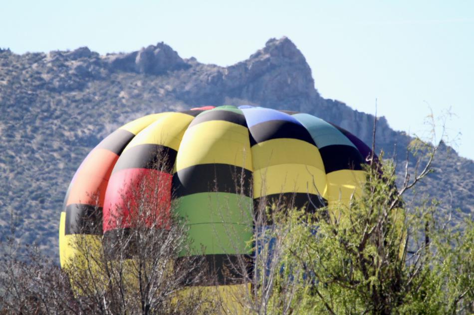 A hot air balloon touches down in a Southeast Carson City neighborhood Sunday morning.