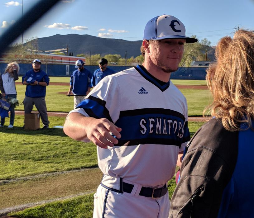 Senior Abel Carter hugs his mother Rhonda during the ceremony.
