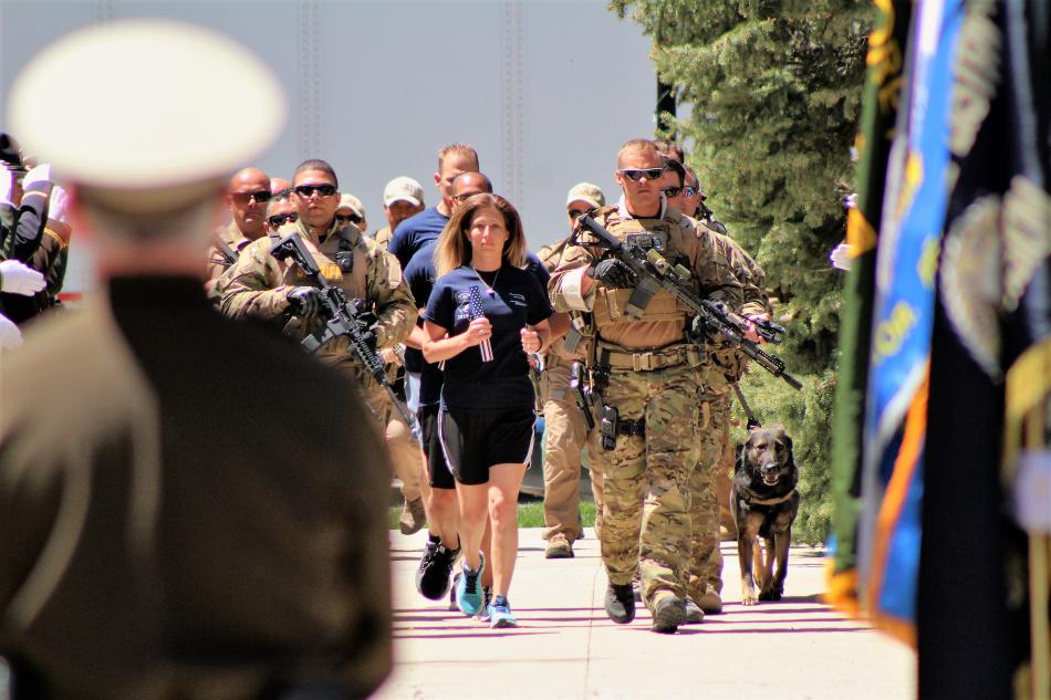 An officer runs the baton onto the Capitol grounds for its ceremonial placement.