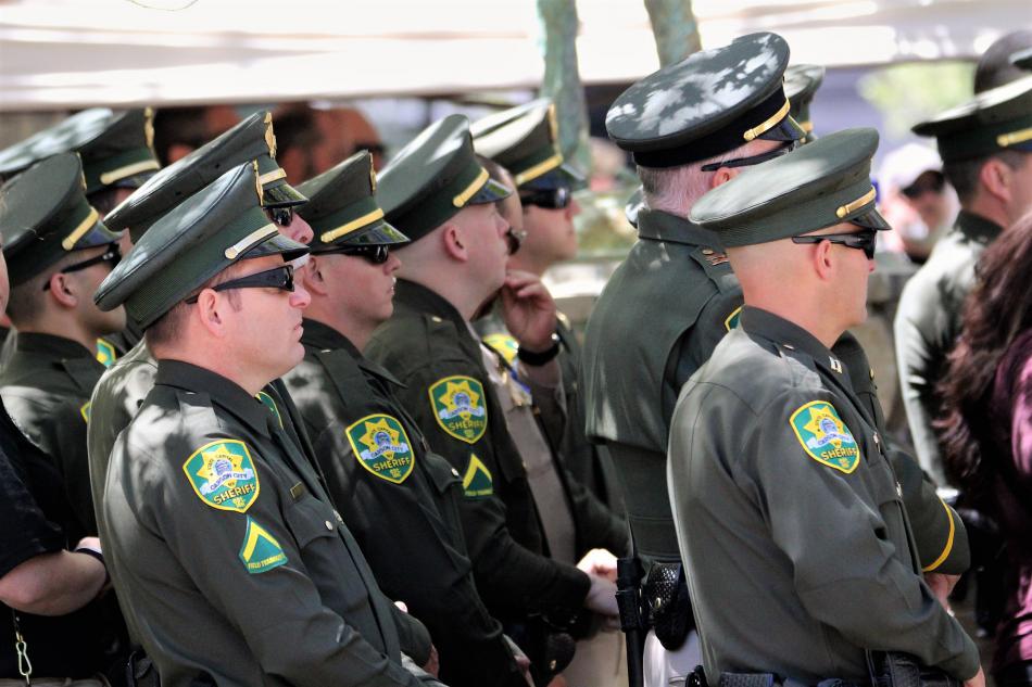 Carson City Sheriff's deputies listen to Nevada Attorney General Adam Laxalt address the crowd Thursday.