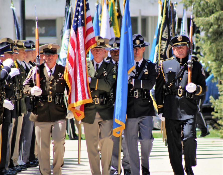 Law enforcement color guard approaches the memorial.