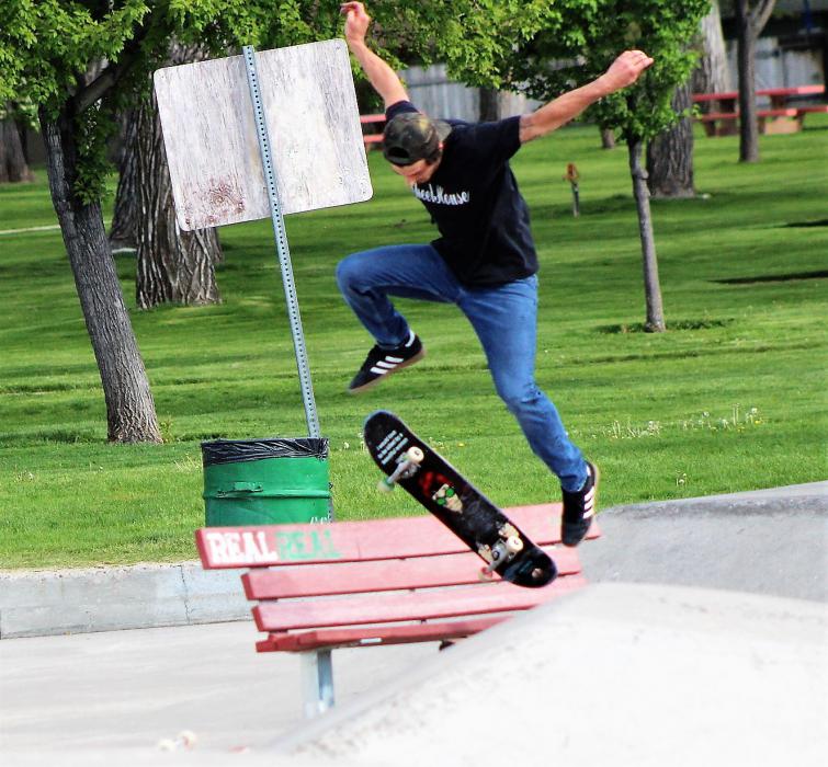 A skate boarder with the Wheel House does tricks at the Mills Park skate park.