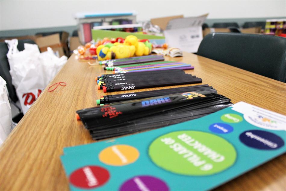 Prizes are laid out on a table to be placed in bags.