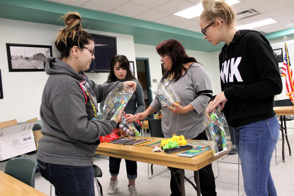 Photos by Brett Fisher. Stellar Squad volunteers work Saturday preparing prize bags.