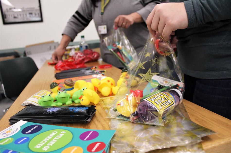Stellar Squad volunteers stuff prize bags Saturday.