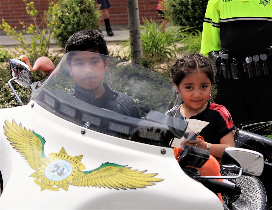 Children sit on a Carson City Sheriff's motor unit Saturday.