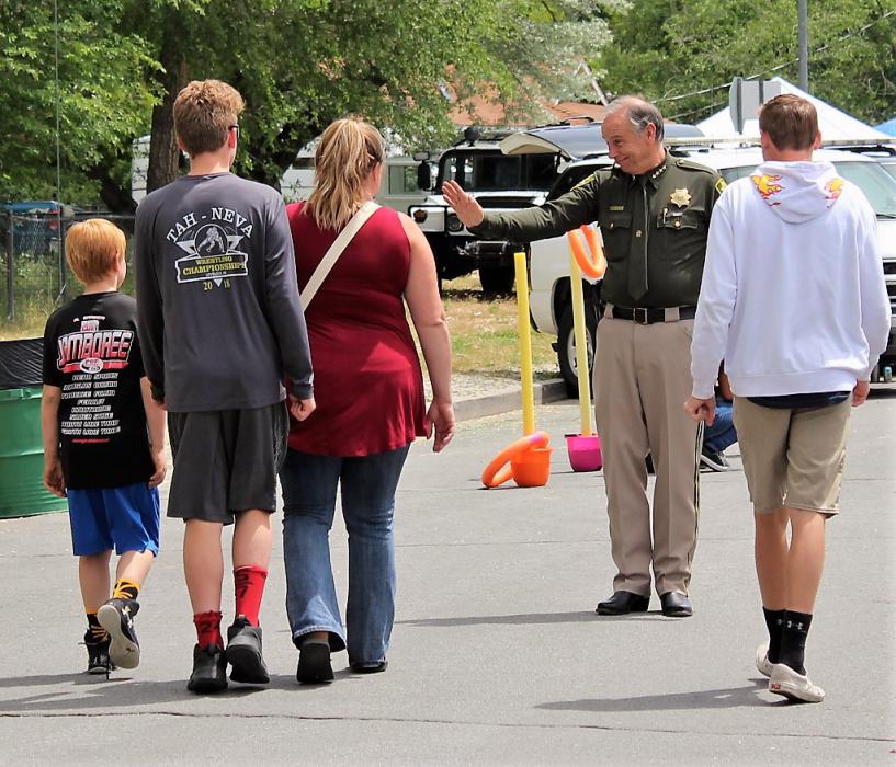 Carson City Sheriff Ken Furlong greets a child and his family Saturday.