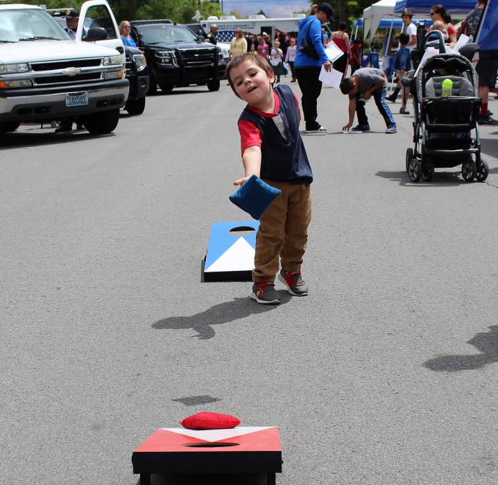 A boy tosses a bean bag toward the target Saturday at the Carson City Sheriff's Office.
