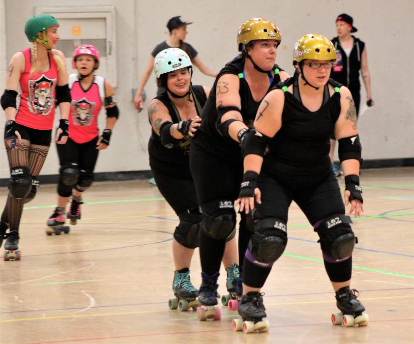 Carson Victory Rollers skaters warm up before their bout.