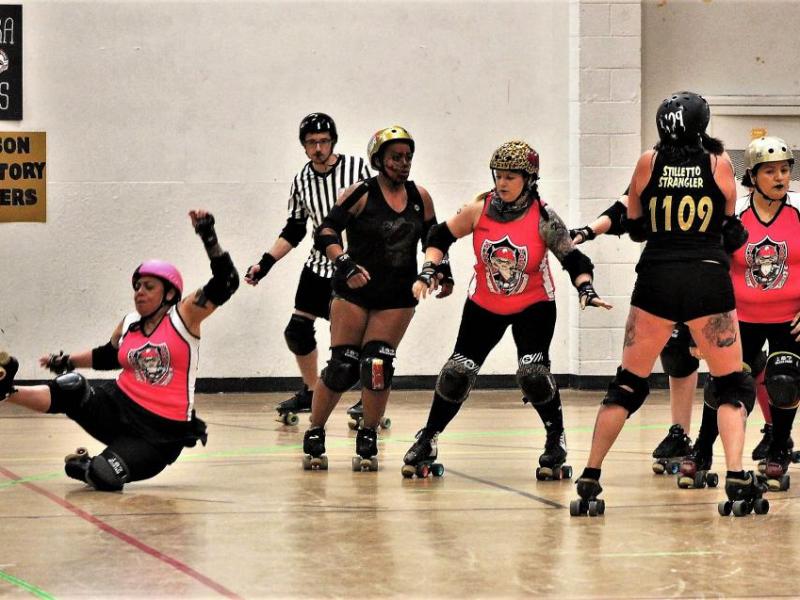 Photos by Brett Fisher. A Sintral Valley skater falls to the floor Saturday against the Carson Victory Rollers.