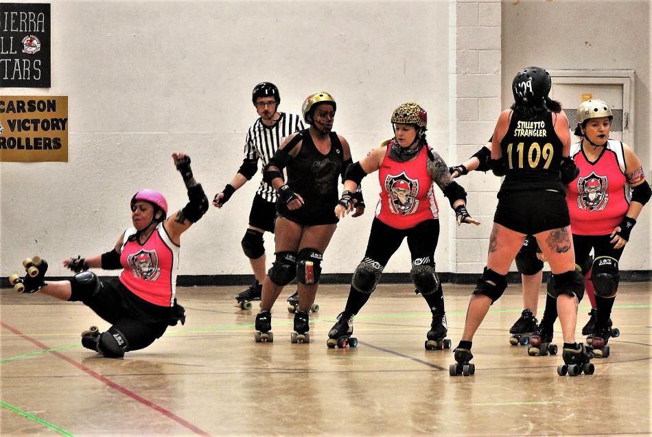 Photos by Brett Fisher. A Sintral Valley skater falls to the floor Saturday against the Carson Victory Rollers.