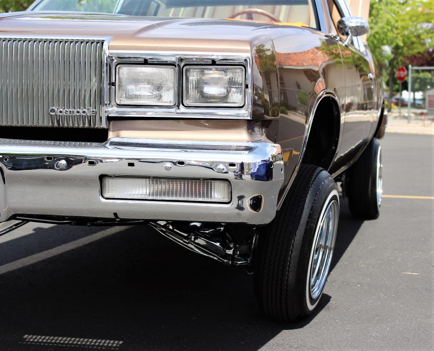 Hydraulic lifts on a vintage 1980s Oldsmobile.