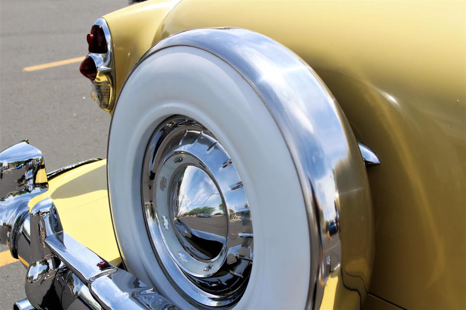 Spare tire cover on a classic 1950s Chevrolet sedan.