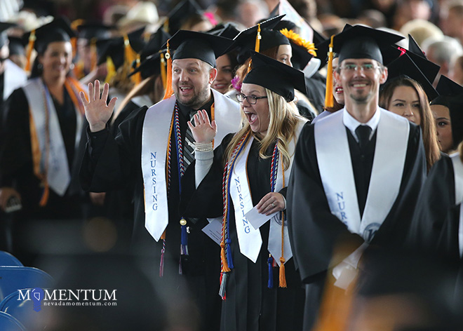 Graduates wave to family and friends as they file in for the 2018 Western Nevada College Commencement ceremony in Carson City.