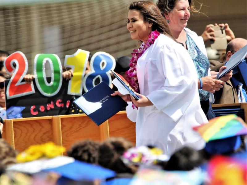 Photos by Brett Fisher. A 2018 CHS graduate crosses the stage upon being handed her diploma Saturday.