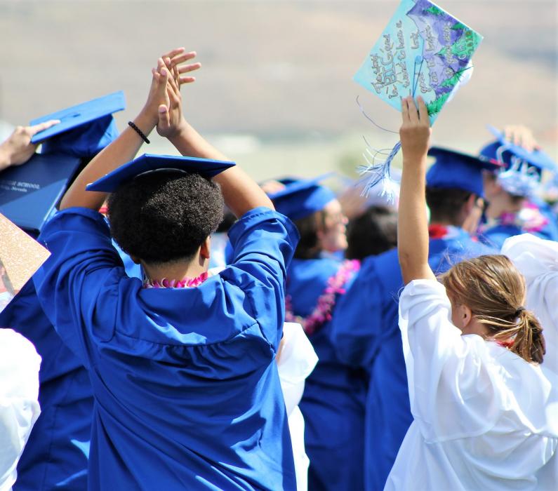 Graduates celebrate after turning their tassels Saturday.