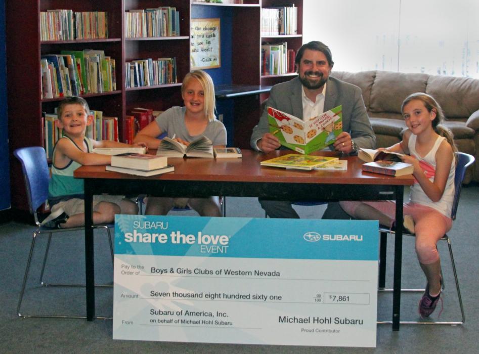 Boys & Girls Clubs of Western Nevada members read along with Matthew Hohl, of Michael Hohl Subaru.