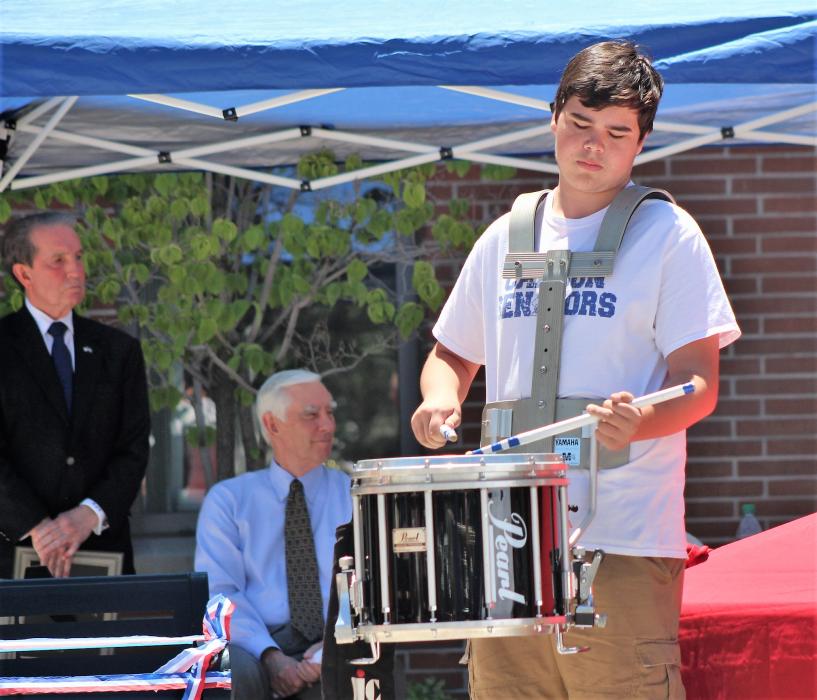 A drummer performs the drum roll with the cannon fire.
