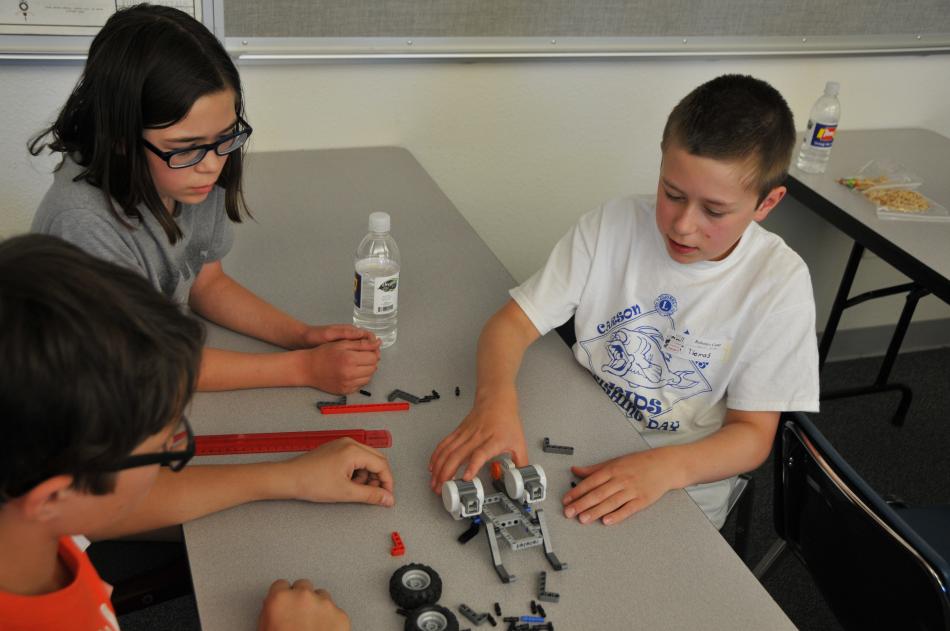 Building a robot base during the Robotics Camp at WNC are (L to R) James Walther, Linda Bathgate and Thomas Bathgate.