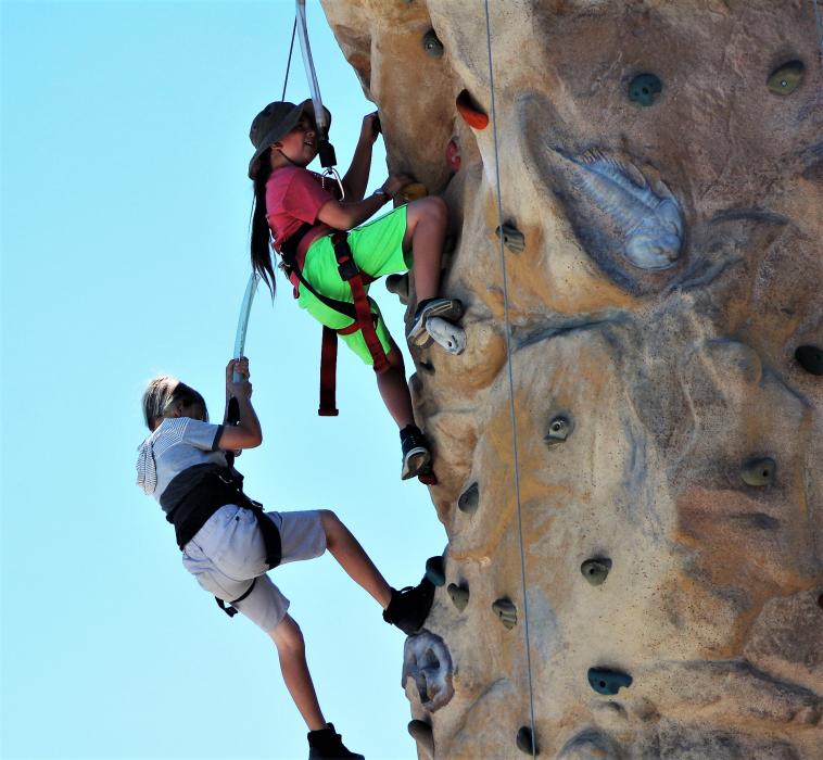 Two girls rapel down the rock climbing wall Saturday at the Nevada Outdoor Experience.