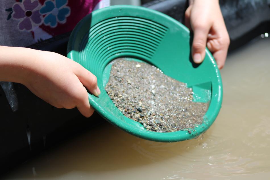 A child looks for gold during a gold panning exercise Saturday.