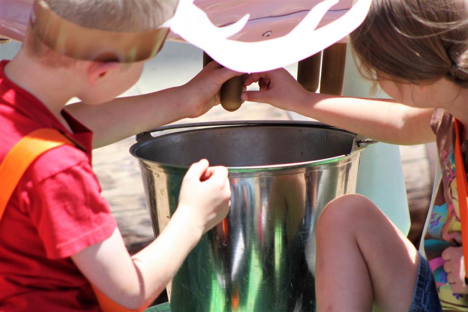 Children learn about milking a cow from a model provided by the Nevada Dept. of Agriculture.