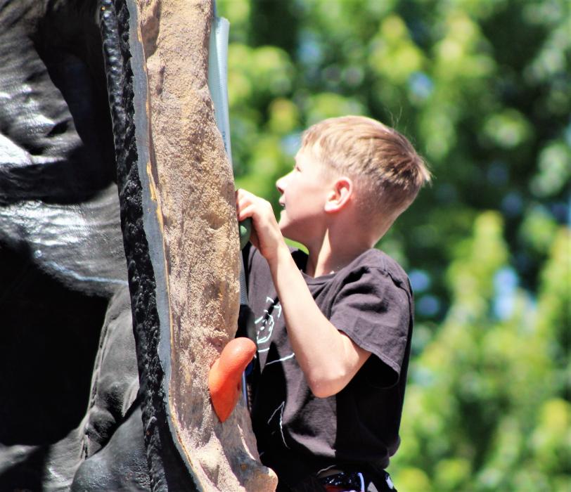 A youth ascends the roll climbing wall Saturday at the Nevada Outdoor Experience.