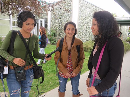 Stephanie Serrano (left) interviews students in the community as a bilingual news intern for KUNR.