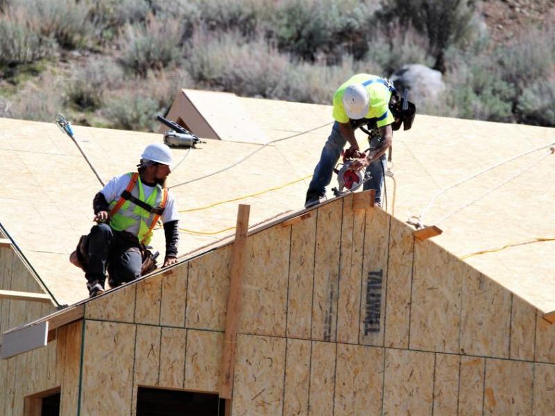 Photo by Brett Fisher. Construction workers on the roof of a new home in west Carson City.