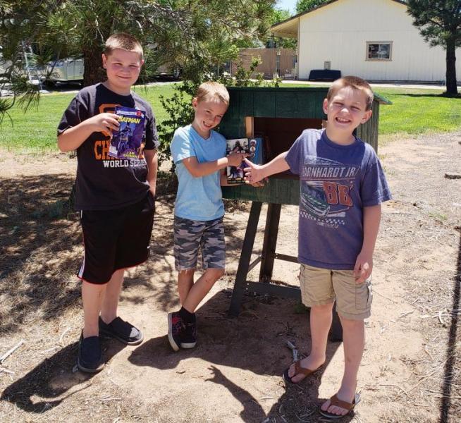 Photo by Chelsy Simerson. The Simerson family poses with their new book box on Ruby Lane.